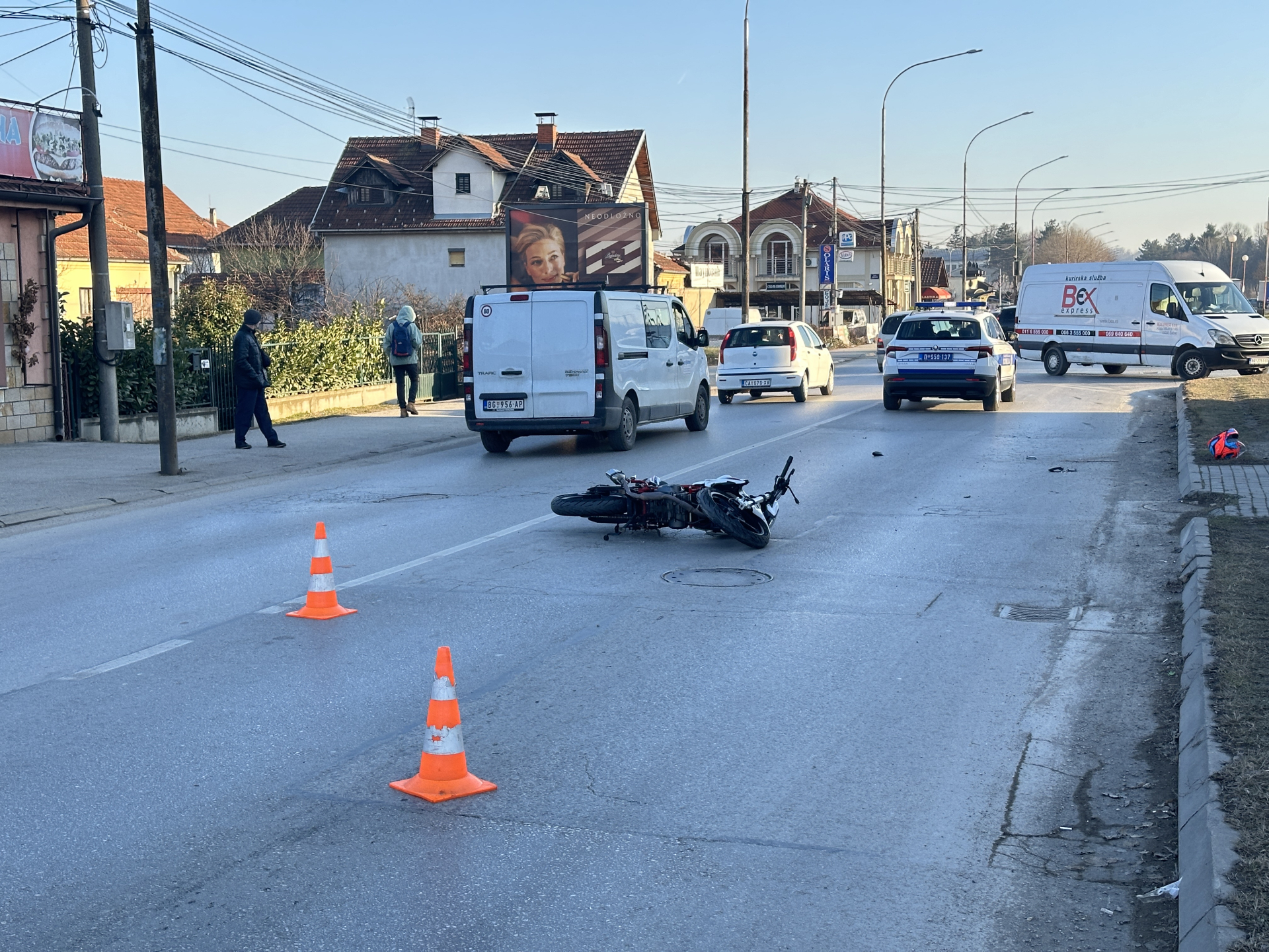 Motor oboren, kaciga na trotoaru: Žestok sudar dvotočkaša i kombi vozila na periferiji Čačka, povređen mladić star 18 godina (FOTO)